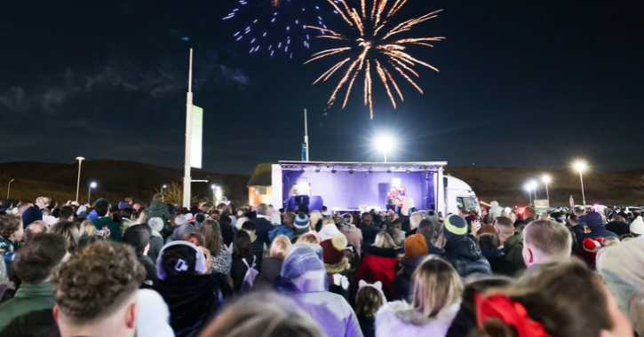 crowd of people stood watching fireworks in front of stage at Dalton Park.